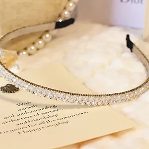 Close-up of double-row crystal beaded headband with silver metallic base and gems