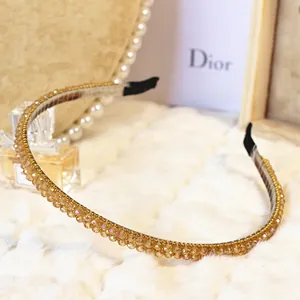 Double-row beaded headband with champagne crystals and black anti-slip tips on fur background