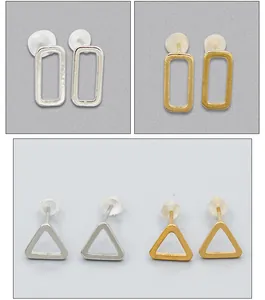 Detailed macro view of minimalist geometric hollow triangle and rectangle stud earrings