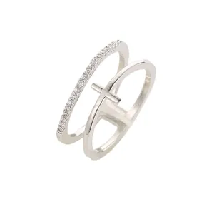 Minimalist double layer silver ring featuring pavé set stones and a cross motif