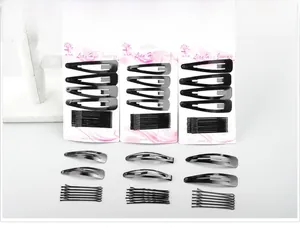 Close-up of black matte hair pin set including snap clips and bobby pins on cards