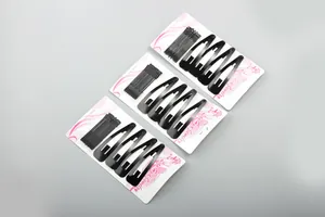 Detail of black metal hair clip set including bobby pins and teardrop snap clips