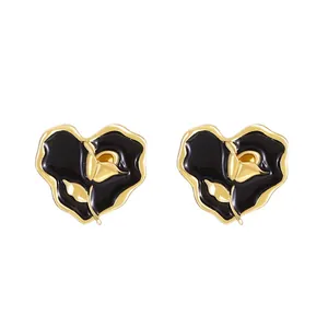 Minimalist black heart stud earrings with golden rose embossing and alloy finish