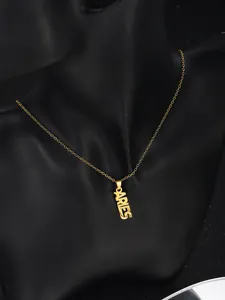 Close-up of 18K gold plated Aries zodiac pendant necklace on a black mannequin display