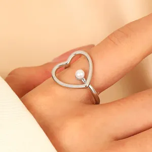 Elegant adjustable silver heart ring with white pearl inlay in a minimalist design