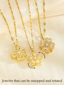 Macro shot of three gold spinning clover necklaces with white cubic zirconia stones