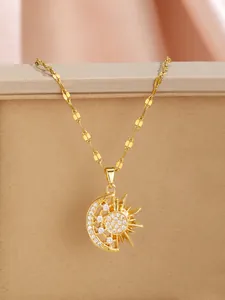 Detailed view of sun and moon pendant necklace with zircons on a golden flat chain
