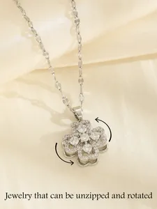 Detail of rotating clover necklace with full zircon inlay on premium silk background