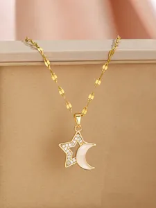 Detailed view of gold star and crescent moon pendant with sparkling zircon inlays