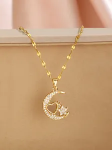 Macro detail of crescent moon pendant with star and heart zircon inlays on gold necklace
