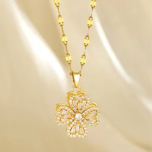 Rotating four-leaf clover pendant necklace in gold with zircon inlay on champagne silk