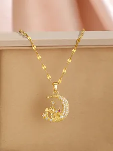 Detail of moon and mosque pendant in gold plating with zircon and red gemstone