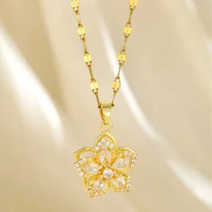 Elegant rotating four-leaf clover pendant necklace with sparkling zircons on silk fabric