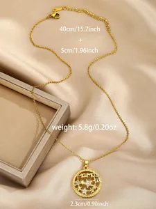 Close-up of golden MAMA pendant necklace with zircon stars on champagne satin