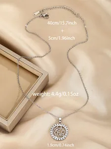 Detail of silver mother and child necklace with zircon stones on gold silk background