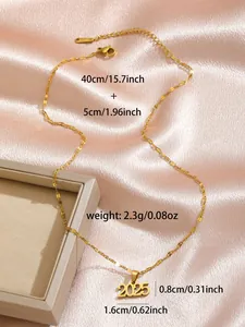 Close-up of gold 2025 pendant necklace on pink silk showing size and weight details