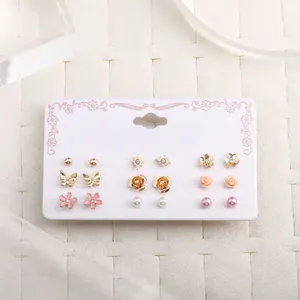 Detail of 9 pairs floral and pearl stud earrings set on decorative display card