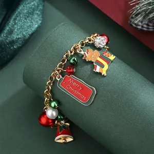 Christmas charm bracelet with gingerbread man and bell pendants on a festive green display