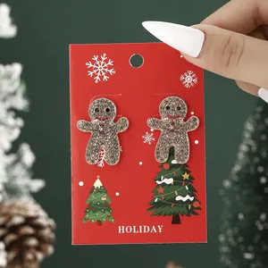 Sparkling gingerbread man stud earrings with champagne rhinestones on holiday gift card