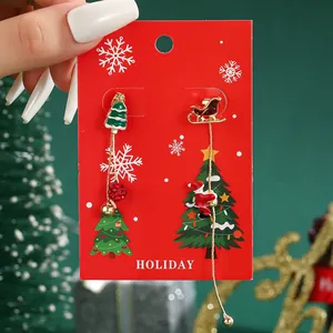 Asymmetric Christmas tassel earrings featuring Santa sleigh and green tree on holiday card