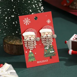 Christmas Santa Claus earrings with red oil drip and pearl tassels on holiday card