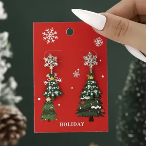 Christmas tree and snowflake drop earrings with rhinestones and pearls on a festive card