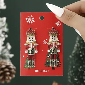 Holiday nutcracker stud earrings with red and green enamel and crystal accents