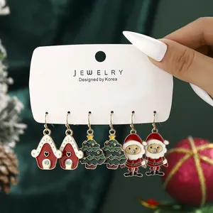 3-pair Christmas earrings set featuring Santa, snow house, and green tree designs