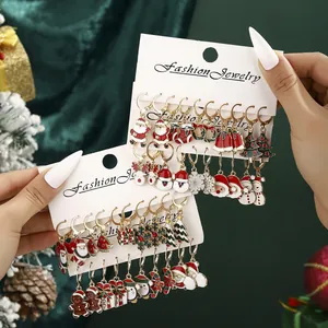 Christmas earrings set with Santa, reindeer, and snowflakes on a white display card