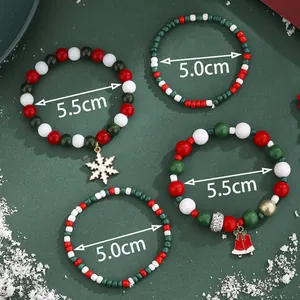 Set of four Christmas beaded bracelets featuring Santa snowflakes and colorful holiday charms