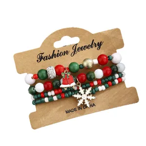 Three-piece Christmas beaded bracelet set with festive red green beads and holiday charms