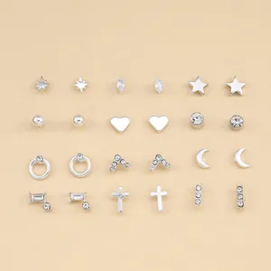 Set of 12 pairs of silver earrings with stars hearts and geometric shapes with zircons
