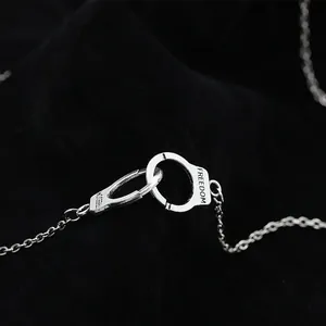Vintage silver-tone handcuff pendant necklace with Freedom engraving on black velvet