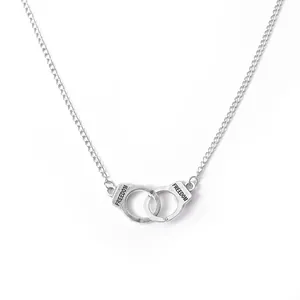 Silver vintage handcuffs necklace with Freedom engraving on a minimalist chain