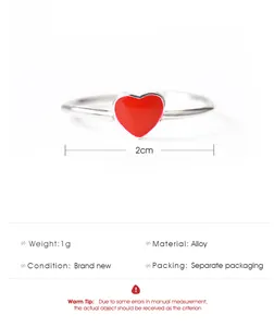 Detail view of silver alloy ring with red heart inlay showing dimensions and weight