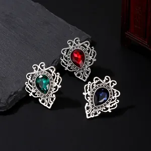 Retro teardrop gemstone brooches in red, green, and blue with intricate silver filigree