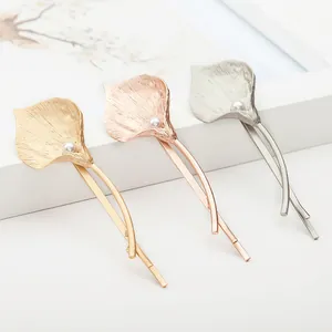 Elegant metal calla lily hair clips with pearl detail in gold silver and rose gold