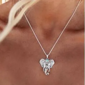 Ethnic hollow elephant pendant necklace with blue gemstone on a delicate chain