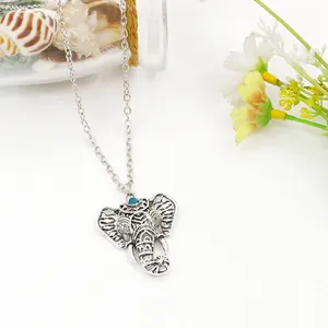 Vintage silver hollow elephant necklace with blue turquoise bead in a bohemian style