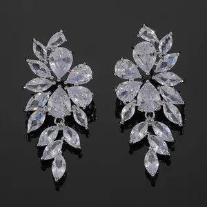 Detail view of luxurious silver dangle earrings with pear and marquise-cut zircon crystals
