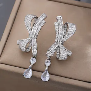 Detailed close-up of crystal bowknot tassel earrings with shimmering zircon water drops