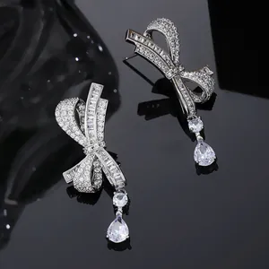Macro detail of silver bow earrings with sparkling marquise and pear cut cubic zirconia