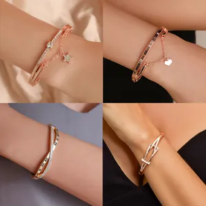 Rose gold bangle set with roman numerals, heart charms, and zircon star accents