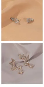 Detail of silver studded butterfly studs and gold crystal butterfly crawler earrings