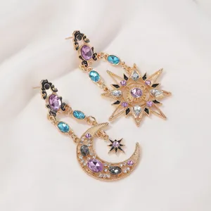 Bohemian baroque sun and moon drop earrings with colorful crystals on white fabric