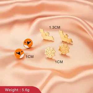 Halloween earring set featuring gold bat, spider web, and orange witch silhouette studs