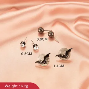 Gothic bat and moon earring set with black studs and cubic zirconia on pink silk