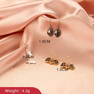 Halloween earring set with silver skull, white ghost, and gold Boo charms on hooks