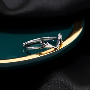 Polished silver adjustable antler couple ring on dark luxury velvet display background
