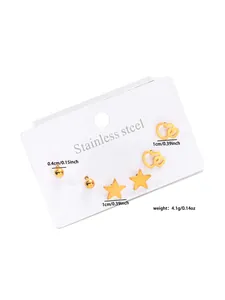 Detailed view of three pairs of gold stainless steel stud earrings in ball, heart and star shapes